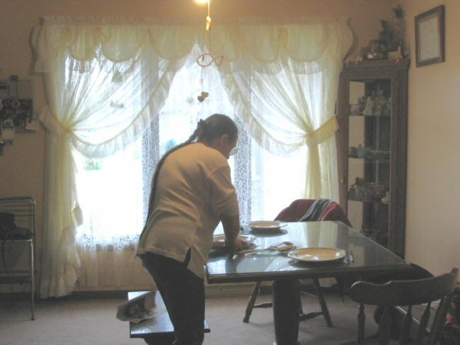 Mom sets the table for Christmas dinner