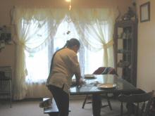 Mom sets the table for Christmas dinner